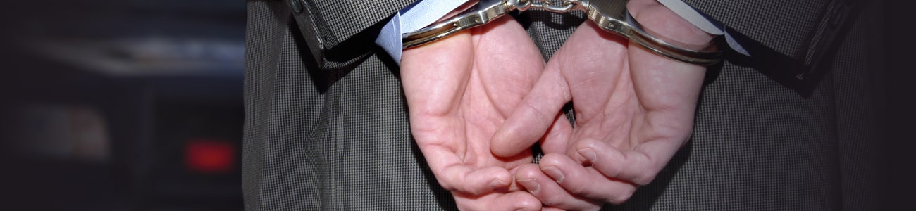 Banner picture of a person in handcuffs