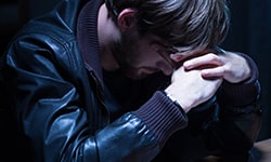 Afflicted man in the dark