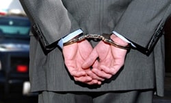 Man in suit with handcuffs